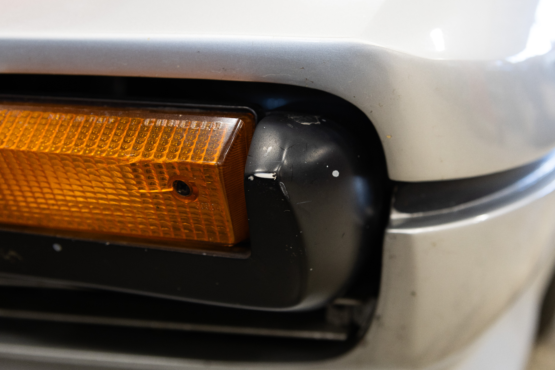 Scuff marks on black bumper corner by indicator