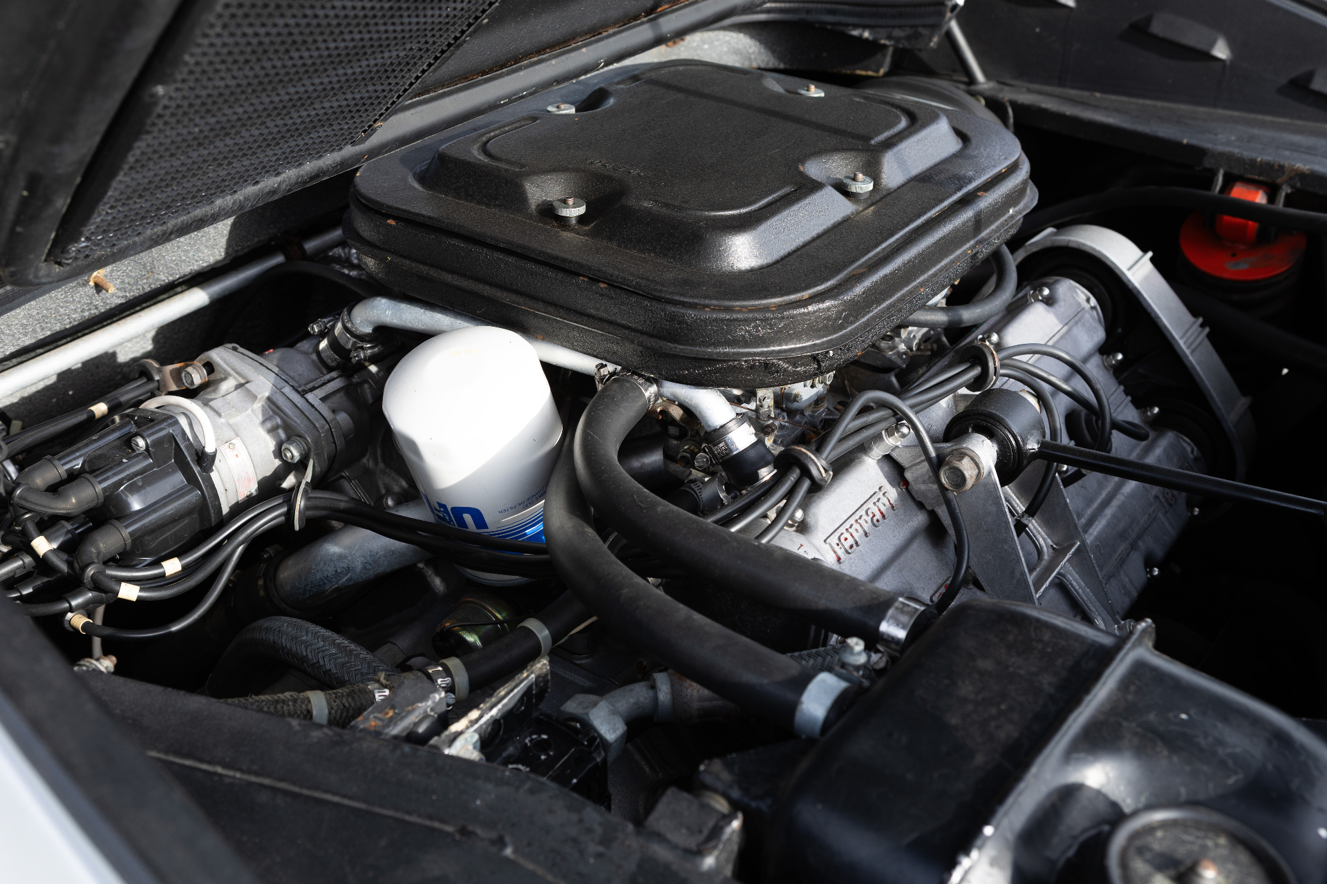 Engine bay with oil filter and carburetors