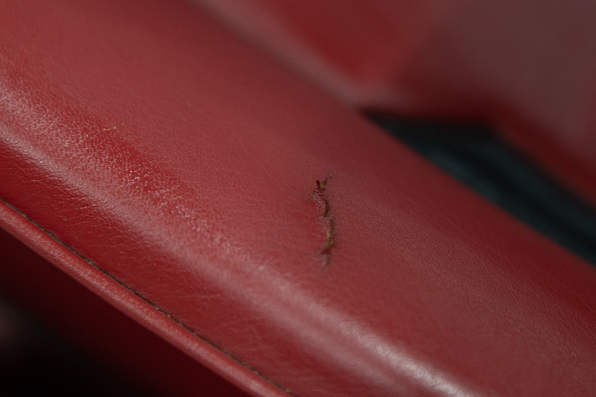 Close-up of small crack in red leather