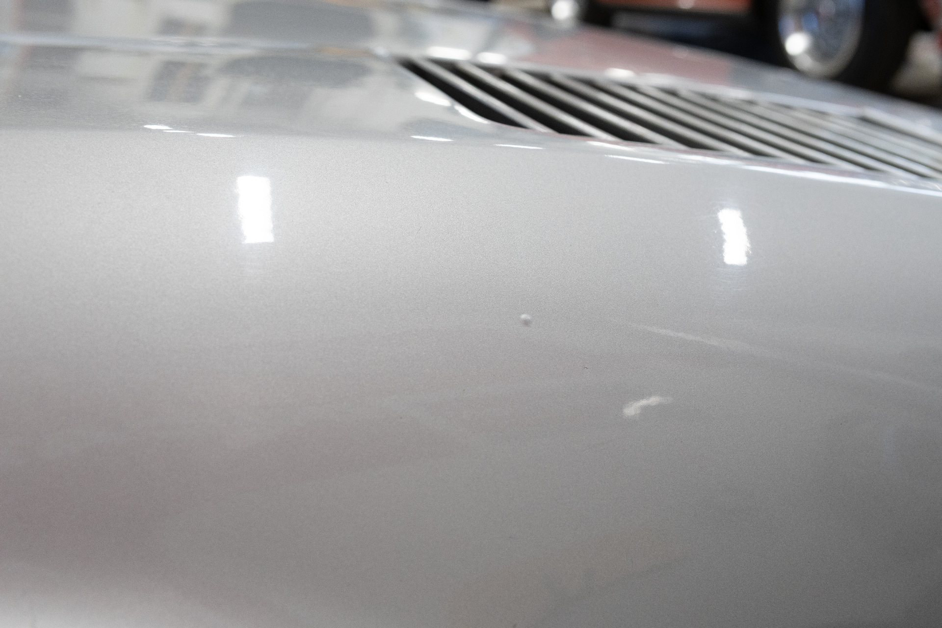 Small paint mark near lower edge of windscreen