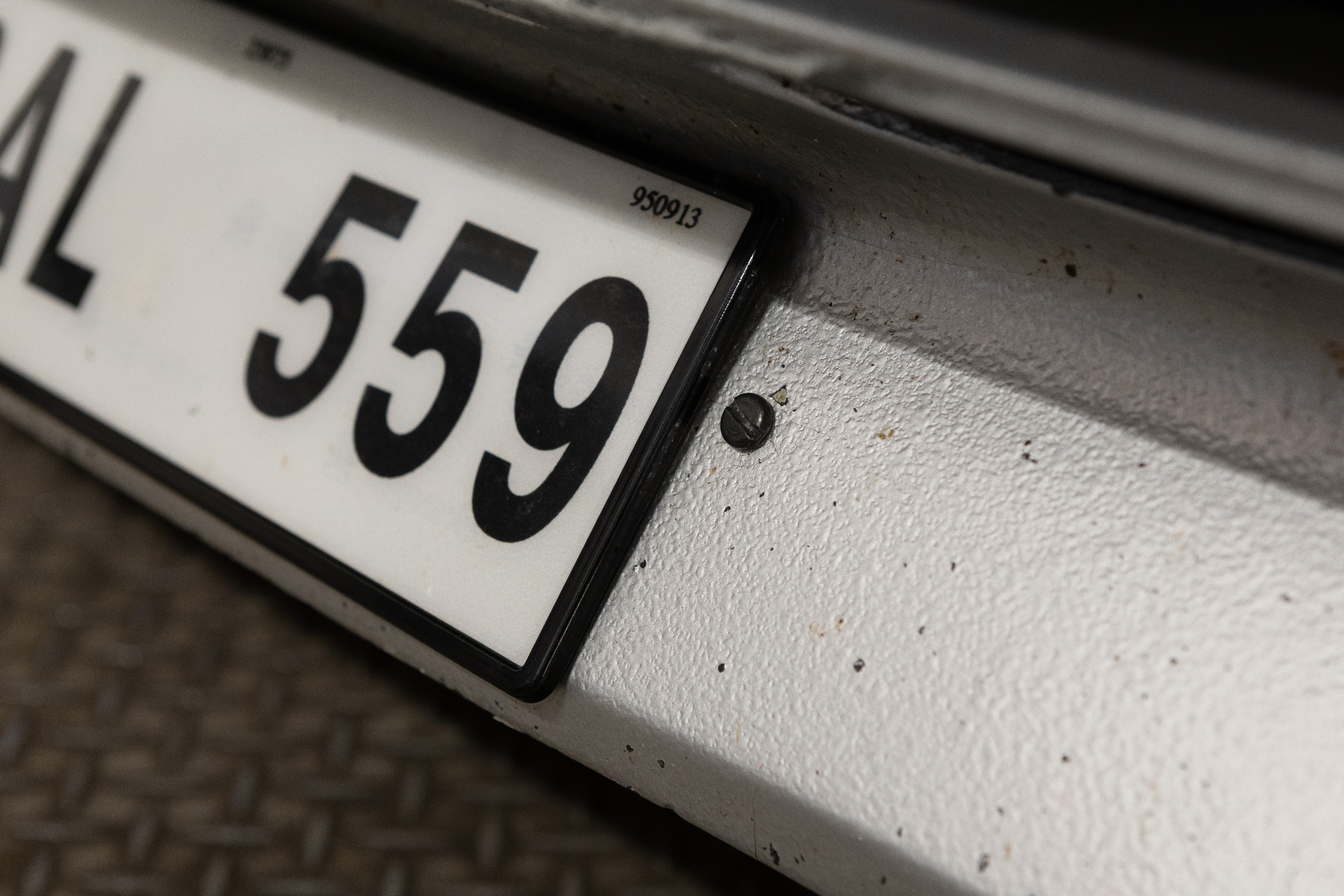Plate holder with original screw and date stamp 950913