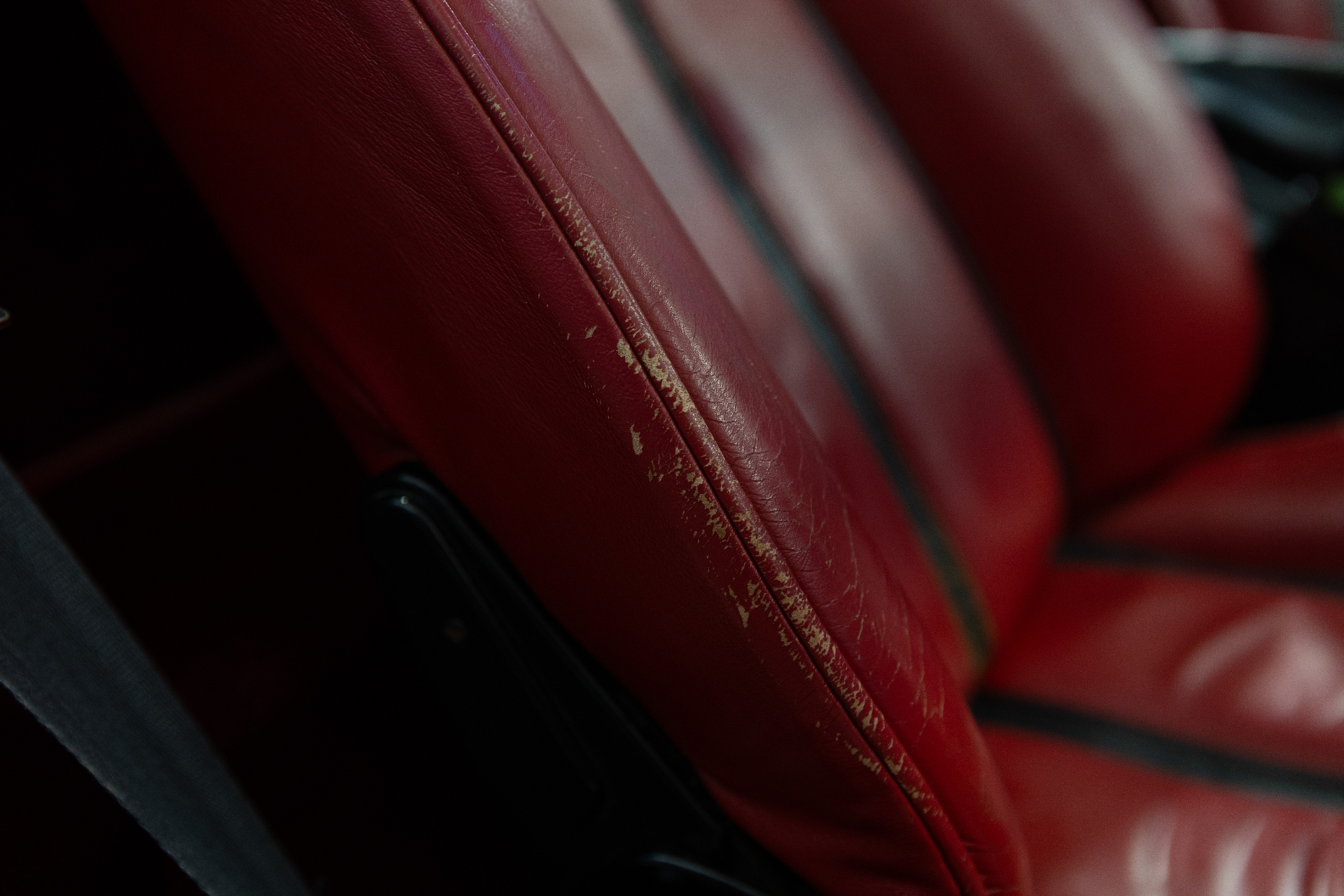 Wear on seat bolster in red leather