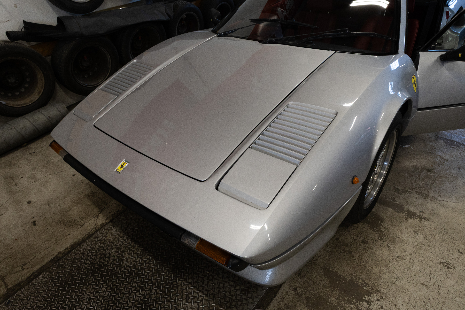 Ferrari 308 GTB front three-quarter view in garage