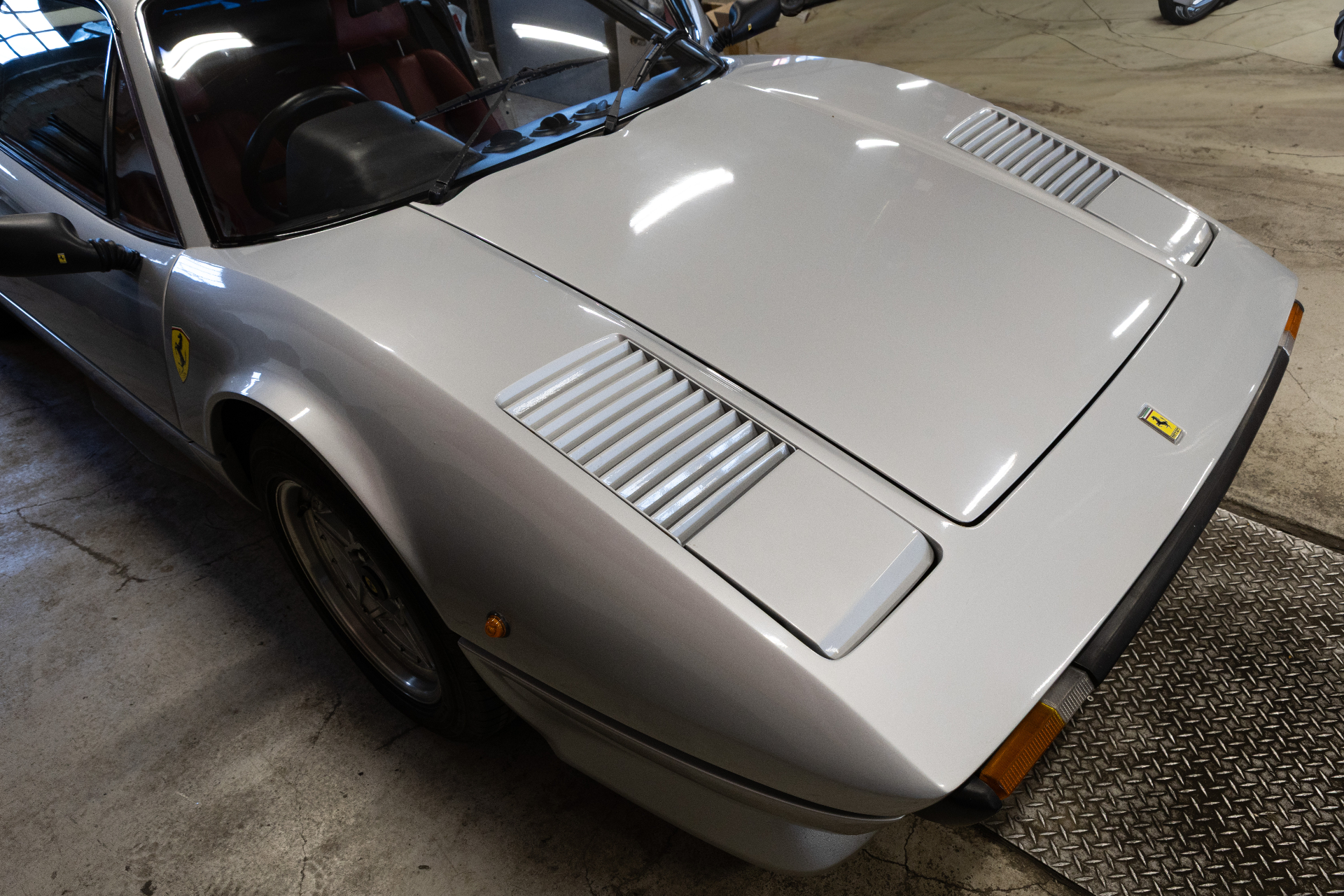 Bonnet with vents and Scuderia shield in garage